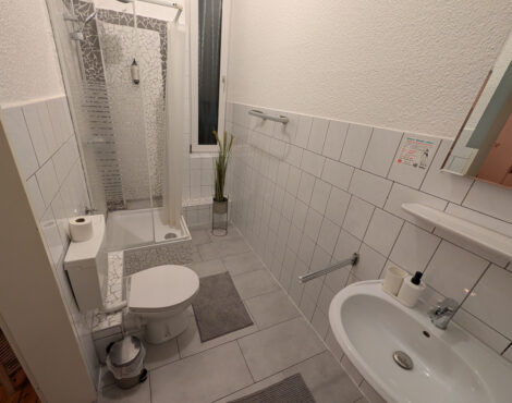 Ein Hotelbadezimmer mit einer Toilette, einer Dusche und einem Waschbecken.